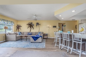 Family room off the kitchen also with stacked sliding doors that open up to the swimming pool.