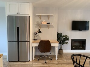 Refrigerator, desk, electric fireplace, TV