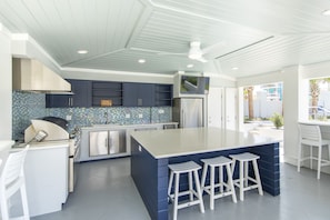 Outdoor covered kitchen with grill and fridge!