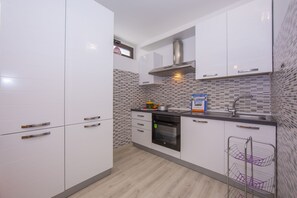 Kitchen with oven, fridge, dishwasher