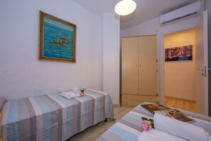 Second bedroom with 2 single beds and air conditioning