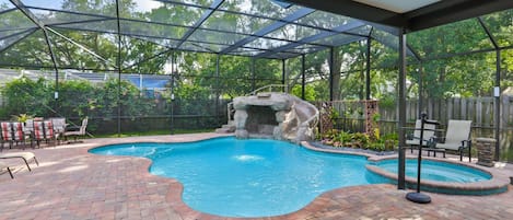 Screened-in, heated pool with a hot tub attached