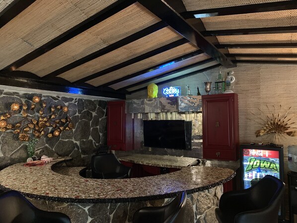 Crescent Shaped Bar with 6 comfy stools and a TV.  
