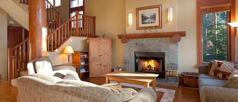 Cozy living room with fireplace, flat screen TV and vaulted ceilings