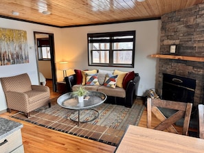 Gooseberry Trailside suites, encampment, living room with wood fire place.