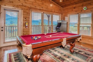 Upper level game room with pool table and multi-cade arcade