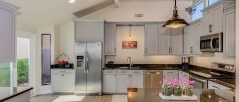 Oversized NEW kitchen with sliding glass door to enclosed patio