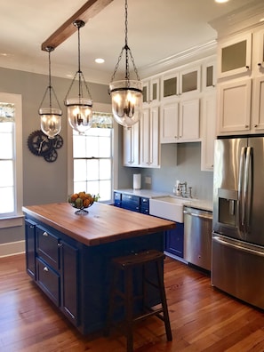 Well-equipped kitchen with many small appliances, dishes, utensils, etc.