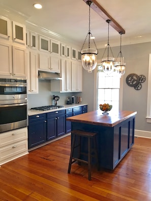Kitchen with 5-burner gas stove and Nespresso coffee maker--we supply a few pods
