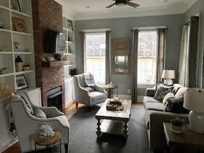 Living Room with sleeper sofa, tv, and gas fireplace