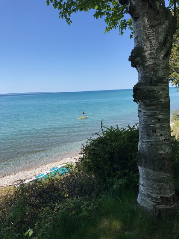 A lone paddle boarder on Lake Michigan in front of the South Manitou condo