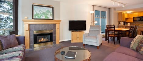 Inviting living area with gas fireplace and TV