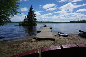 View of dock and island from sandy beach