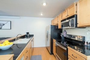 Fully stocked kitchen offers all the full-sized appliances you need and ample counter space for cooking meals at home.