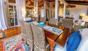 The screened-in porch is thoughtfully furnished with a dining table and seating for eight.