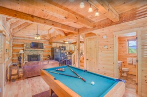 Downstairs Pool Table, Living Room, Kitchen, and Bathroom.