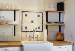 Classic Talavara Tile with a farmhouse sink and butcher block counter.