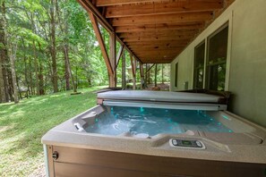 Hot Tub Sits Just Above Back Yard