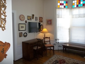 A nice workspace/desk and a flat screen TV with Roku player and Wi-Fi.