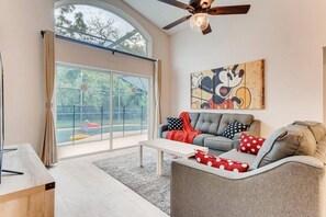 Bright and spacious living room with stunning pool views