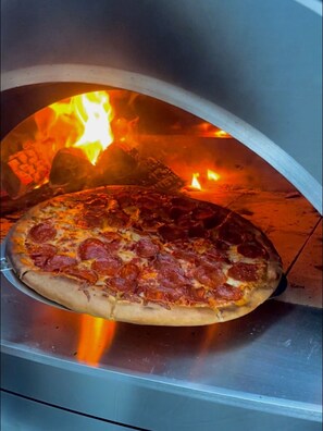 Make delicious homemade pizza in our full size professional wood burning oven.