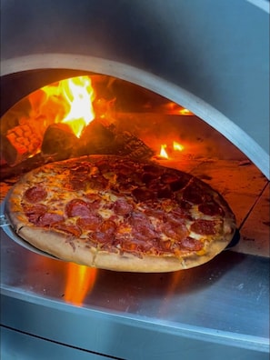 Make delicious homemade pizza in our full size professional wood burning oven.