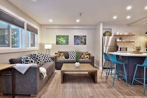 View of the bright and cheery living room and open kitchen.