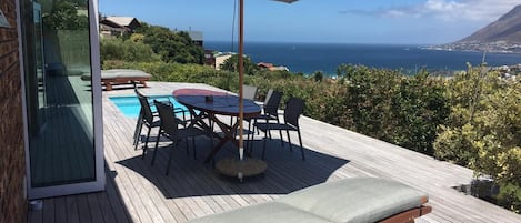 Views from the deck with table, 6 chairs Pool loungers and a big bag 