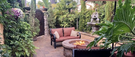Tranquil private tropical courtyard with fire pit.