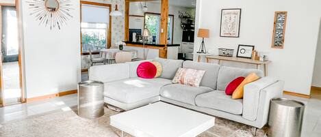 Bright sunny living room, marble floors, comfy sofa