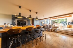 Ground floor: Large open-plan kitchen with stairs leading to the sofa area and garden