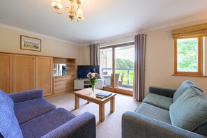 Light Airy sitting room leading out to the balcony.