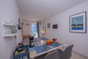 Living room dining area with view of the lake access to terrace with lake view