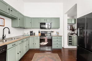 The fully-stocked kitchen has everything you'd need to cook, serve, and enjoy meals together.