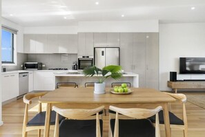 The kitchen is filled with natural light, making it a pleasant space to cook and dine