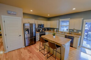 The kitchen island provides extra seating and prep space for cooking.  