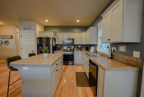 The kitchen has gas cooking, newer appliances, loads of gadgets, & meal basics.