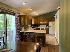 Fully stocked kitchen with gas stove and snack bar for additional seating