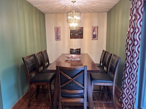 Dining room table with 8 or 10 chairs, plus an additional 4 stools for the peninsula snack bar.
