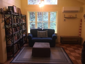 Entry & reading nook; ottomans open for more seating. Great spot for reading!