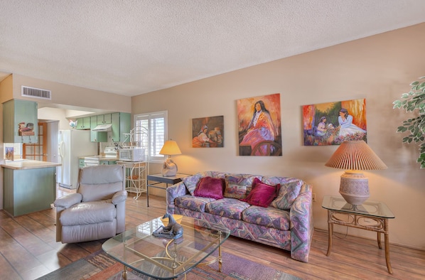 Queen hide a bed. Spacious living room with two chairs and sofa.