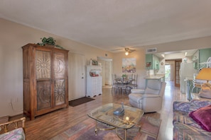 Wood flooring living area with dining.