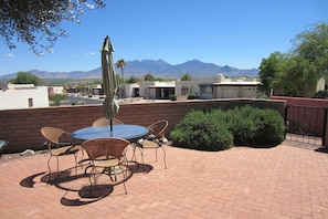 Back east facing patio with table and nine chairs. Great views of Santa Ritas.