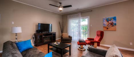 LIVING ROOM - 
This is a large gathering room with an Electric Fireplace, sofa bed and comfortable recliner chair. Large windows keep this room light and airy. The sliding door lead to the private balcony.