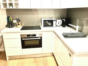 Full kitchen with large fridge, freezer, dishwasher, oven, cooktop, M/wave etc