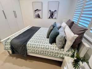 Queen bedroom with wardrobe and hangers