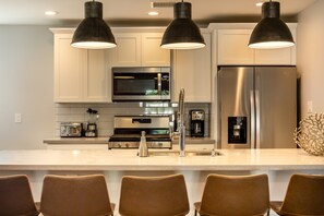 Cook in style with a fully equipped kitchen featuring sleek stainless steel appliances and ample space for meal prep.