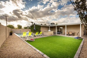 Your private backyard oasis with a heated pool, fire pit, and BBQ grill—ideal for sun or sunset relaxation.