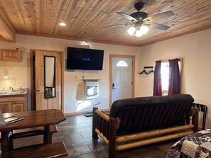 Entry door and couch with new 55” Roku TV that includes an Amazon subscription
