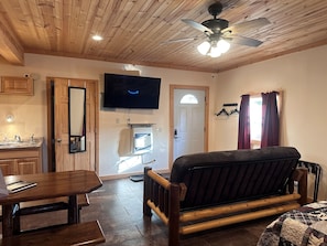 Entry door and couch with new 55” Roku TV that includes an Amazon subscription